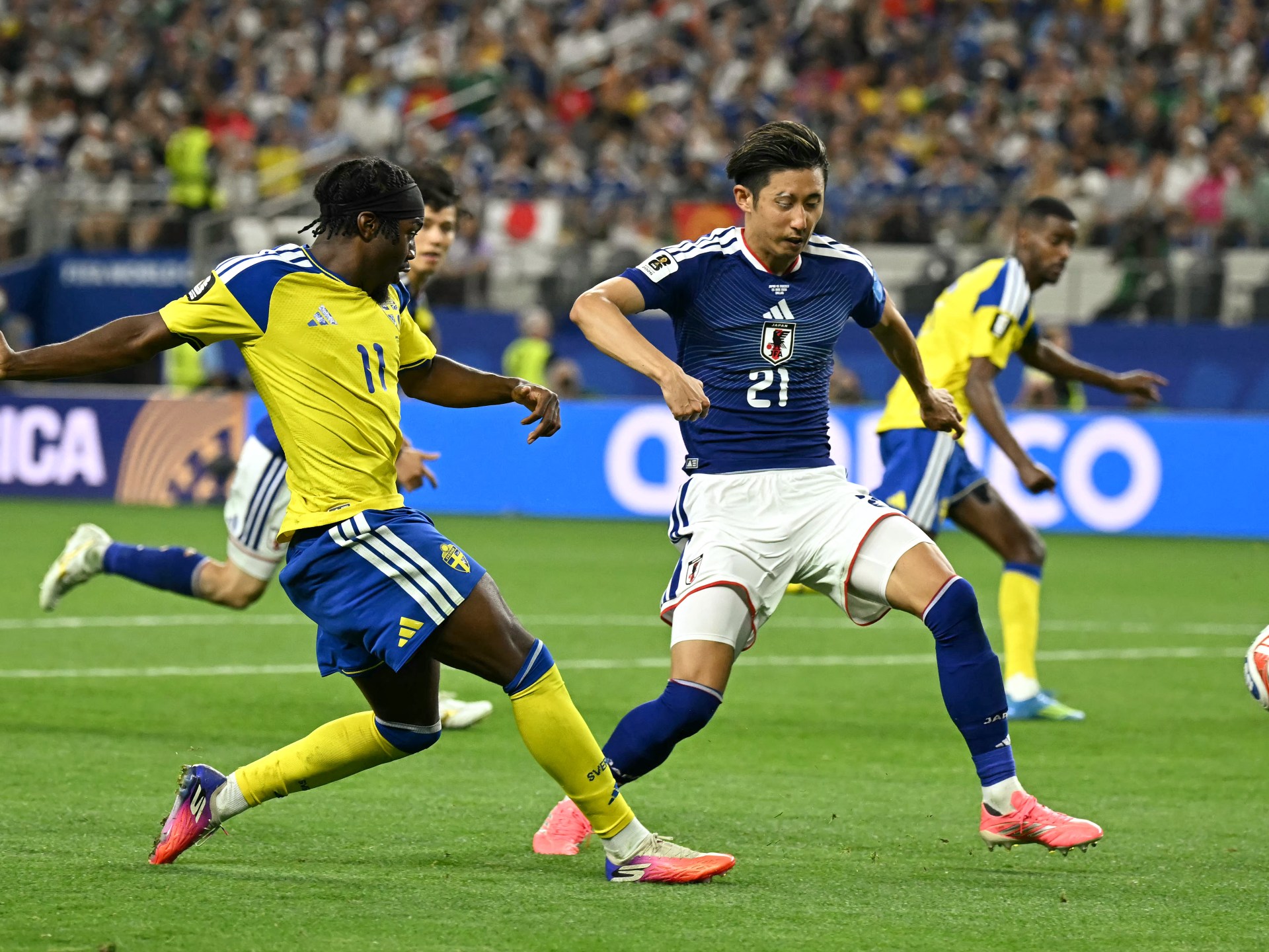 Japan holds off Sweden to secure second place in Group F